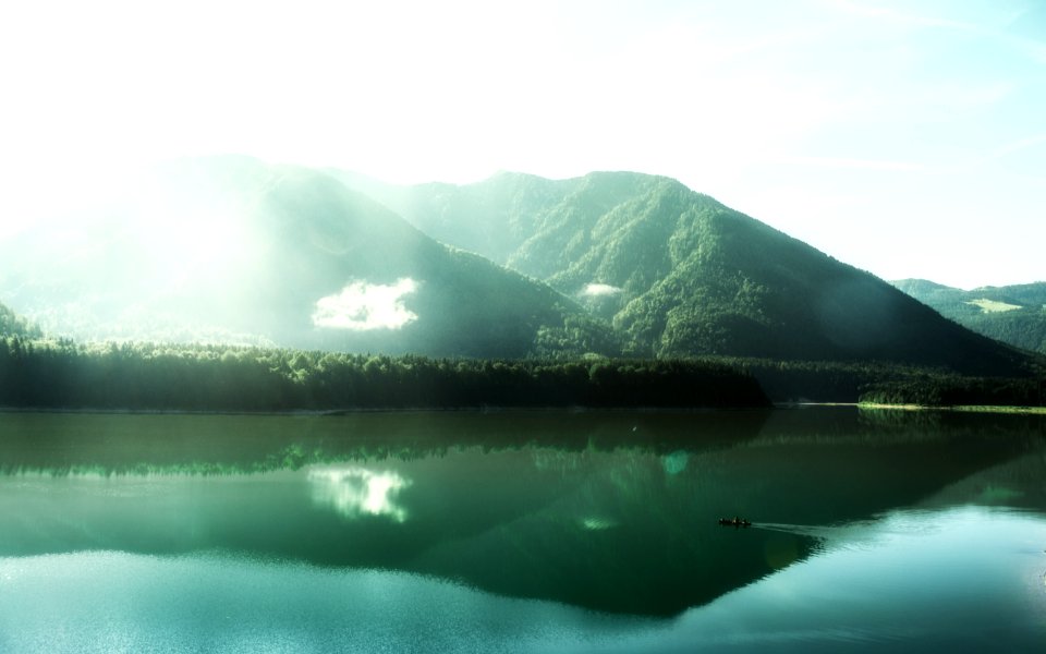 panoramic photography of boat on body of water near mountains at daytime photo