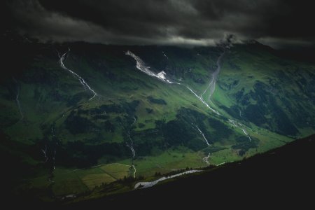 green mountain under dark cloudy sky photo