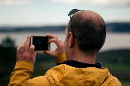 man taking picture of nature photo