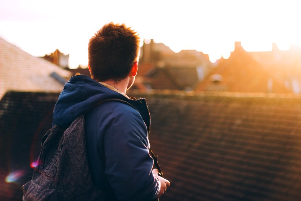 man facing on brown roof on rooftop