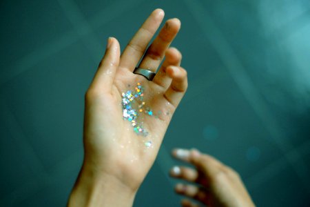 person showing hands with glitters photo