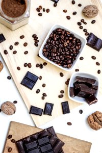 chocolate and coffee seeds on table near bowls