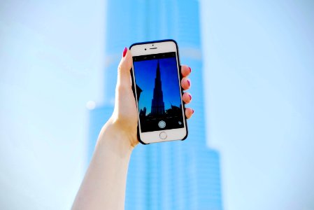 person holding silver iPhone 6 and black case photo