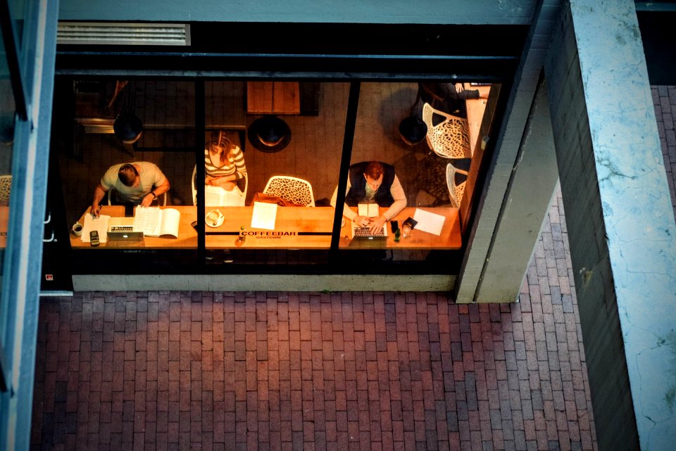 three persons sitting on chair beside table photo