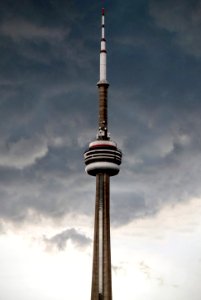 brown and white metal tower under cloudy sky photo