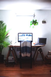 black flat screen computer monitor on brown wooden table