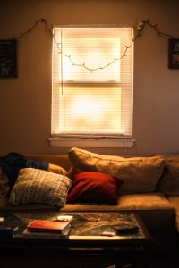 red throw pillow on brown couch photo