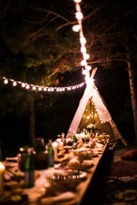 A large dinner table outside with special lighting. photo