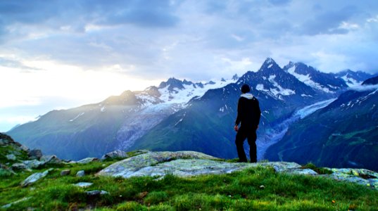 person standing in front of mountain landscape photography