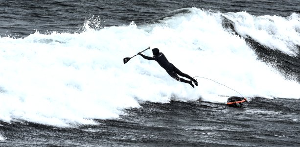 man riding surfboard photo