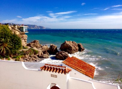 white and brown concrete building near sea during daytime photo