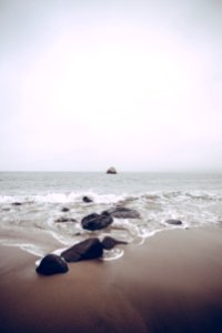 rocks on sea side at daytime photo