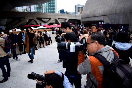 group of photographers holding DSLR cameras in event during daytime photo