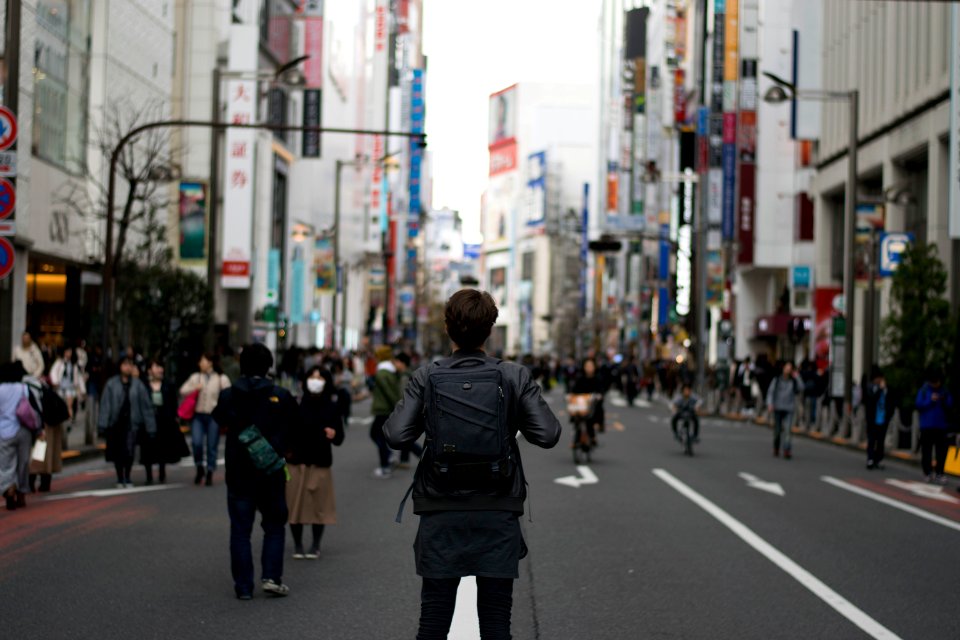 shallow focus photography of person carrying backpack