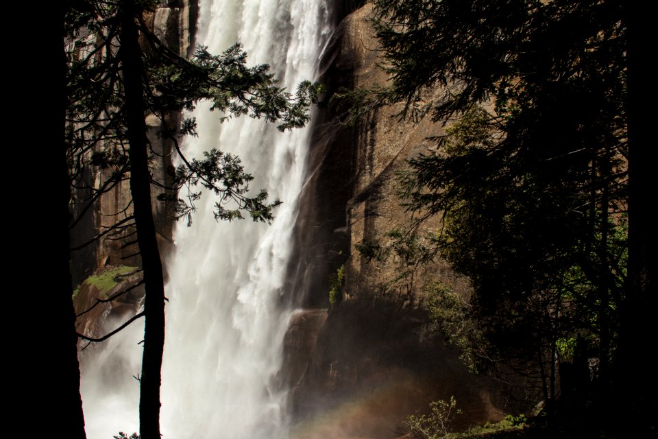 waterfalls beside mountain and trees