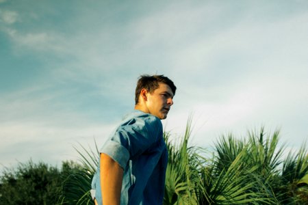 man wearing blue chambray top