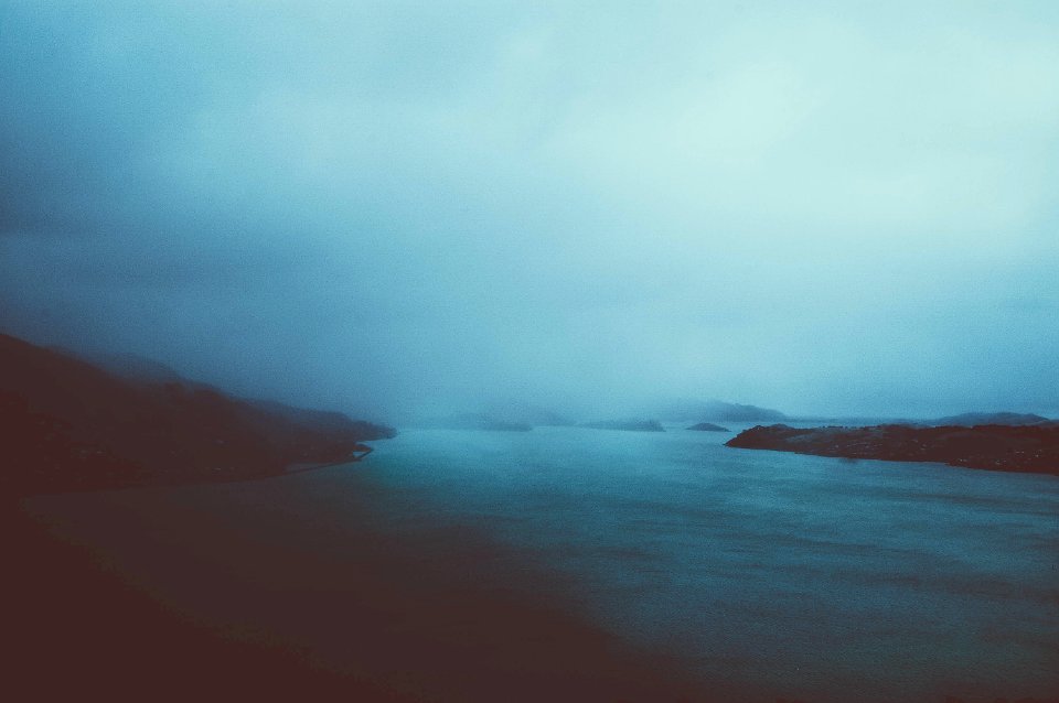 cloudy sky over calm body of water