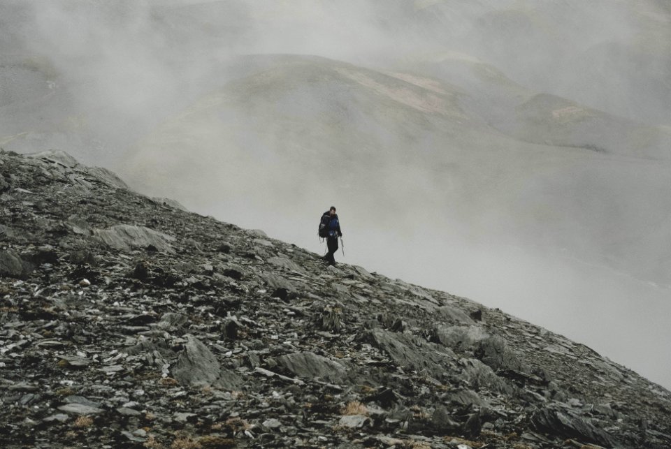 mountaineer climbing down on mountain