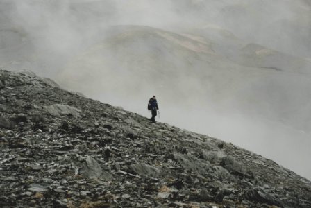 mountaineer climbing down on mountain photo
