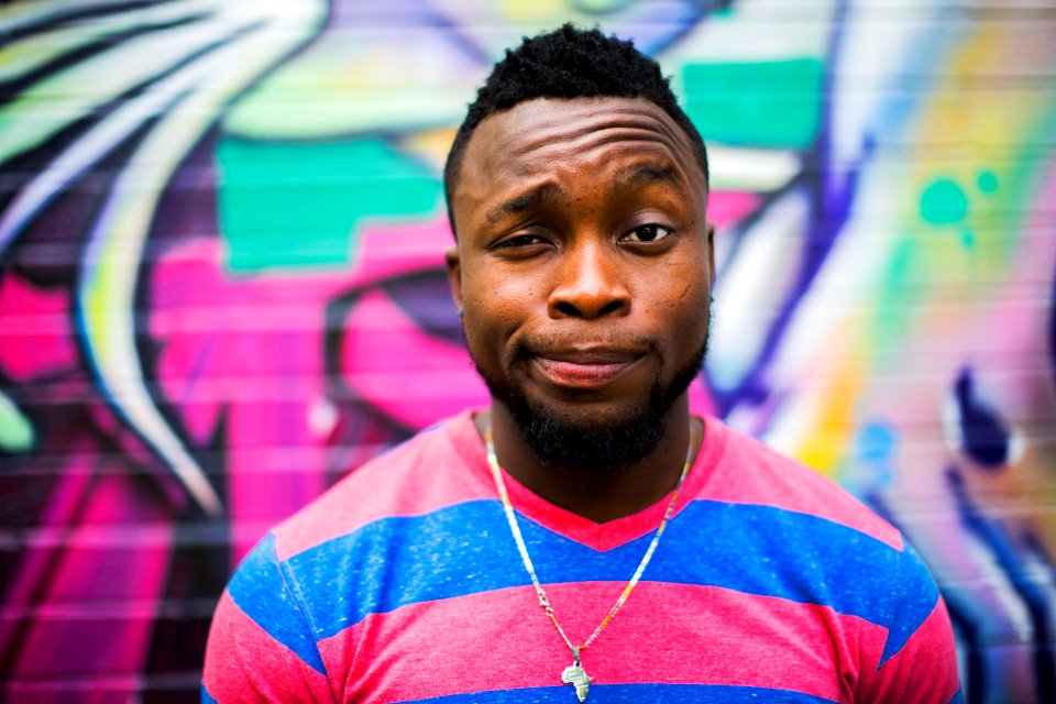 black haired man making face