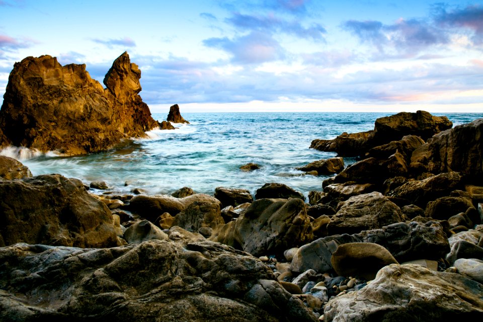 rock formation in sea at daytime