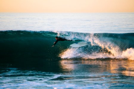 man surfing under wave photo