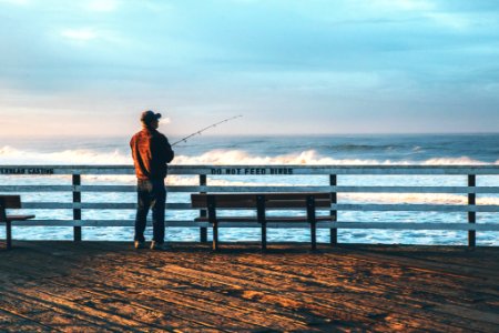 man fishing on seaside photo