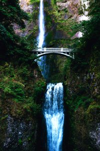 white bridge over waterfalls during daytime photo