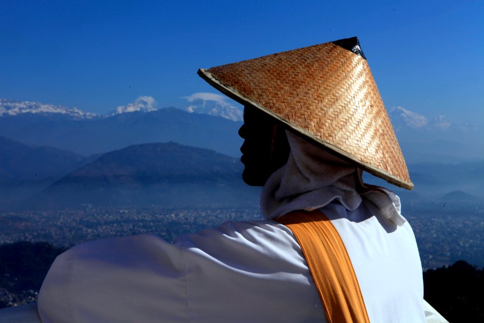 person wearing brown hat looking through during daytime