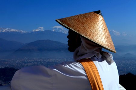 person wearing brown hat looking through during daytime