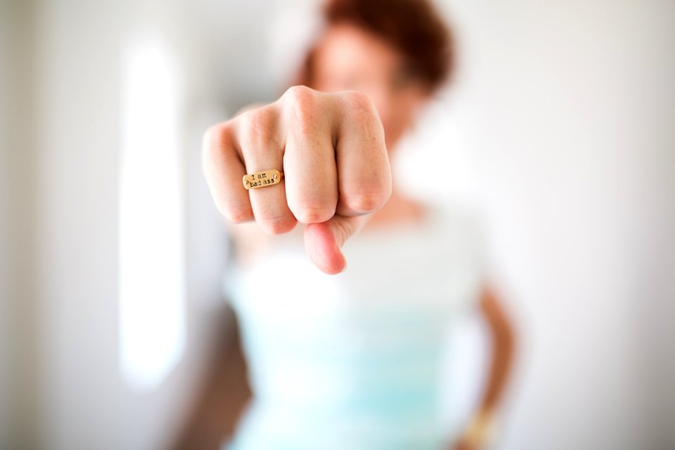 woman showing gold-colored ring