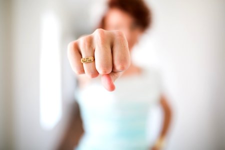 woman showing gold-colored ring