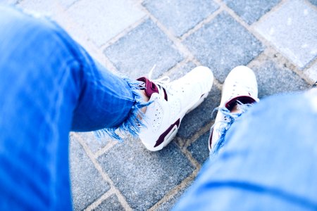 person wearing pair of white Air Jordan 6's photo