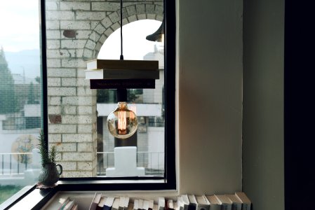 clear glass pendant lamp inside white and brown concrete room during daytime photo