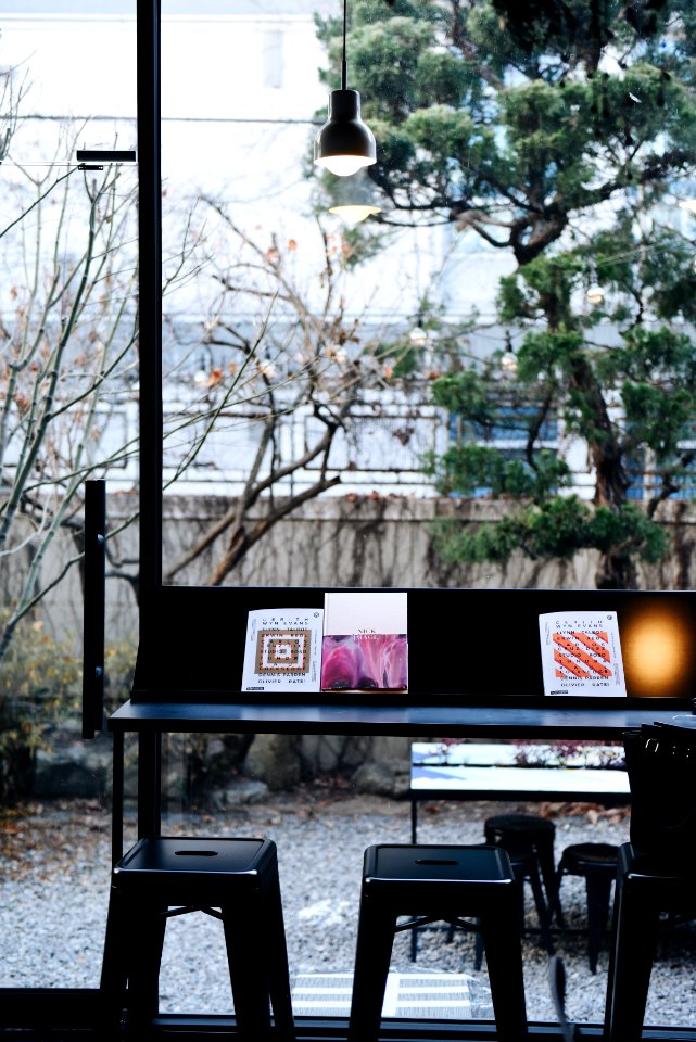 photography of black desk and two black bar stools
