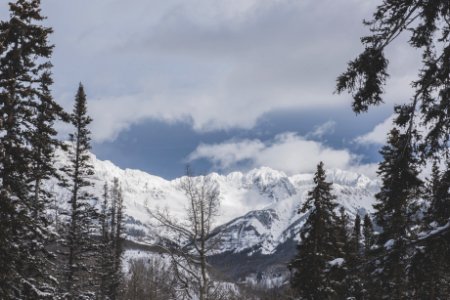 snow covered mountain under cloudy sky