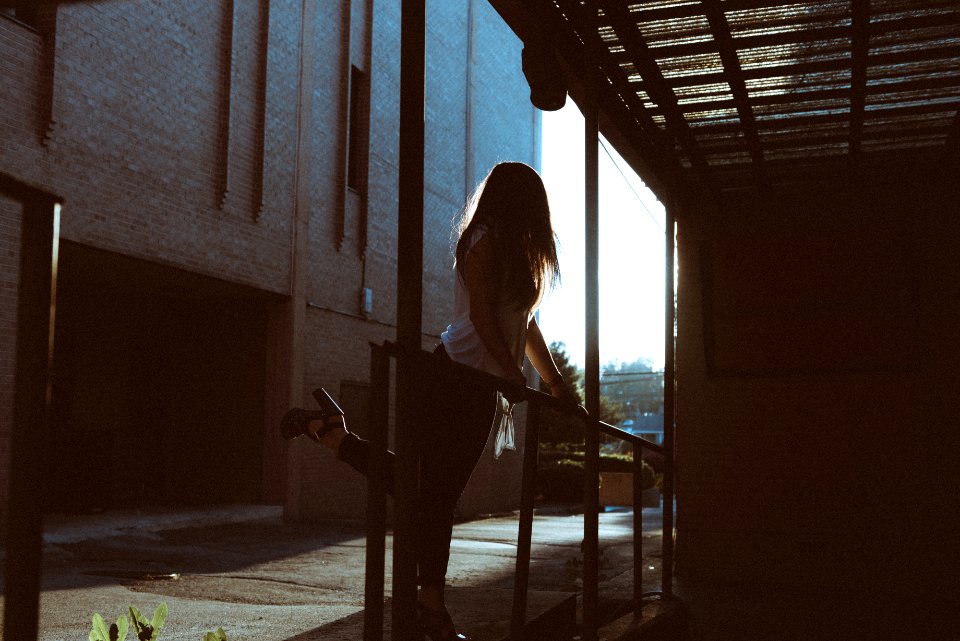 woman standing in front of metal rail