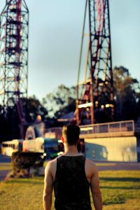 standing man wearing black tank top looking at towers photo
