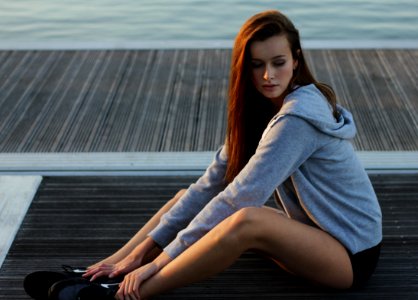 women's gray hoodie doing yoga photo