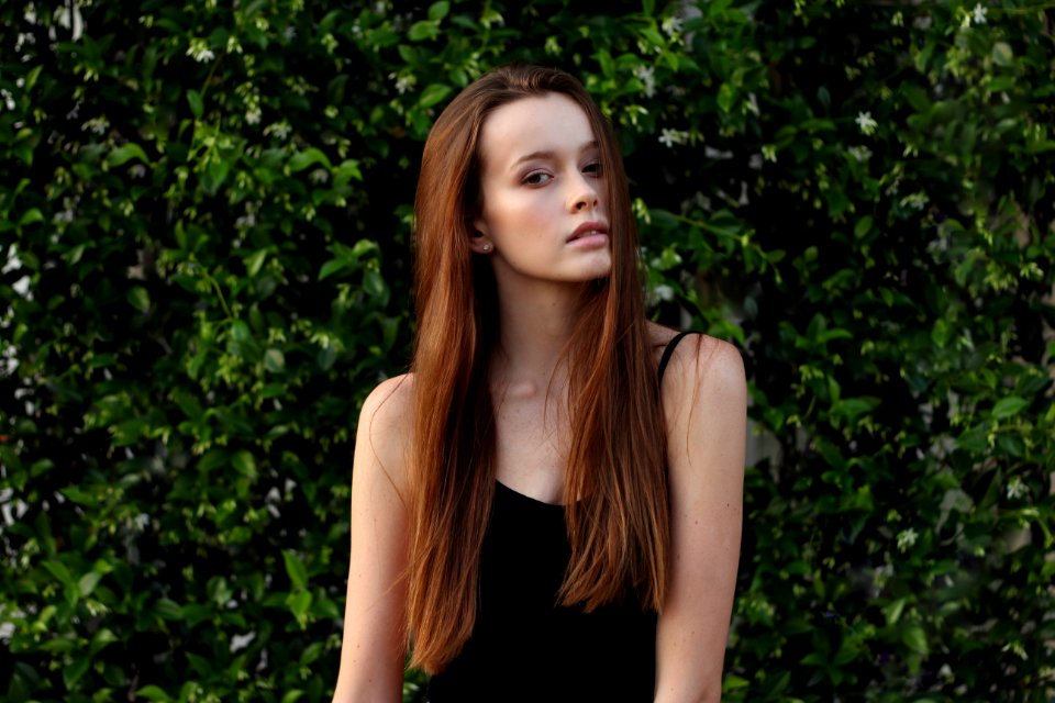 woman wearing spaghetti strap top in front of bush