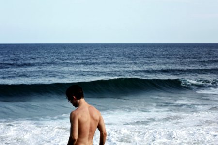 man standing in front of ocean photo