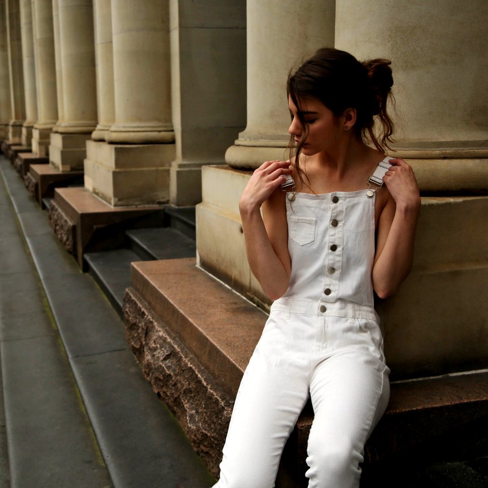 woman sitting and leaning on wall
