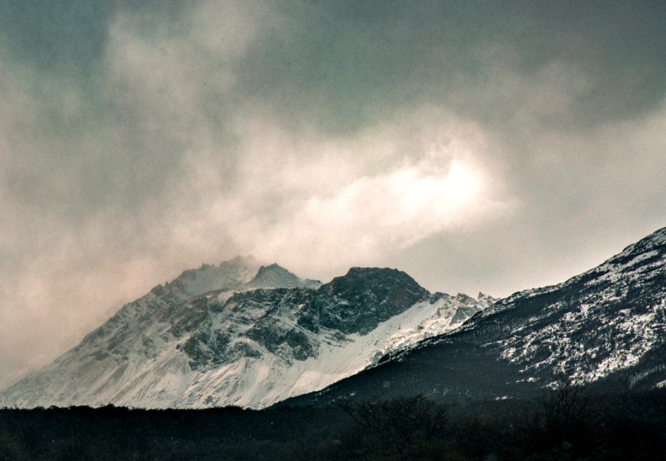 snow covered mountaan under gray sky