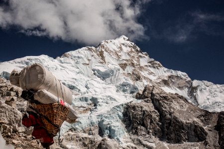 man near mountain under cloudy blue sku photo