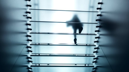 low-angle photo of person walking on frosted staircase photo