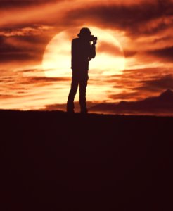 silhouette of man standing during daytime photo