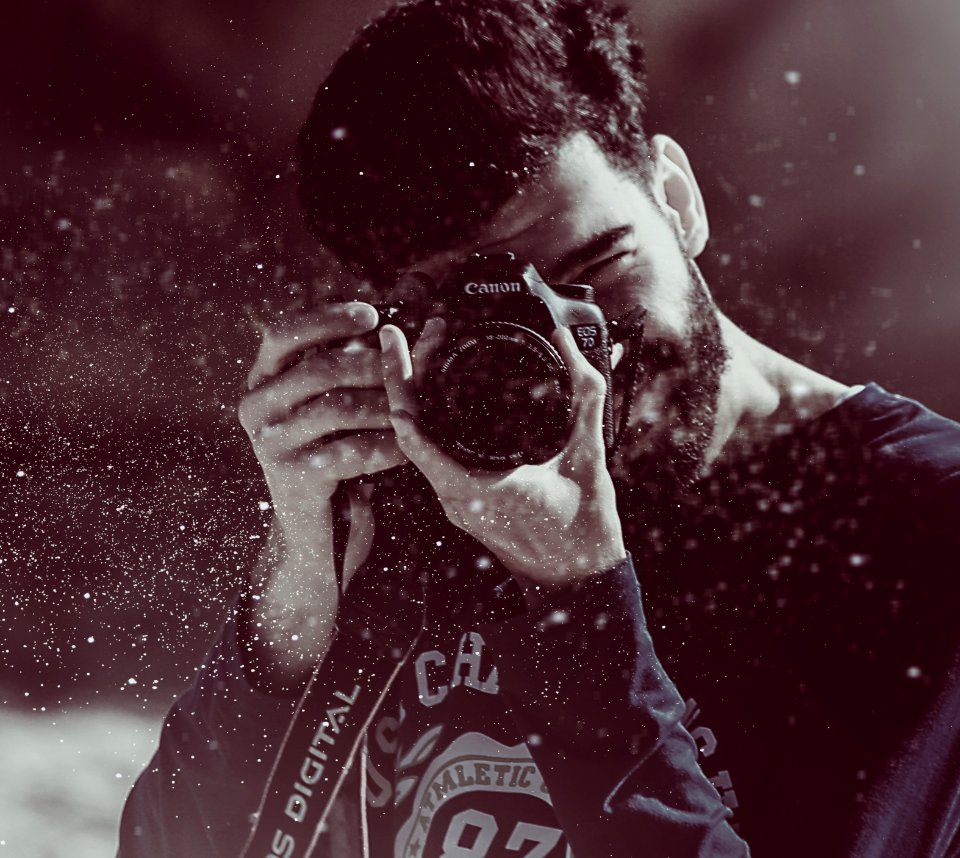 photography of person taking photo using Canon camera photo