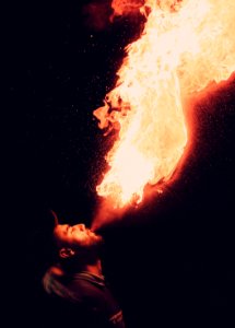 man blowing fire photo