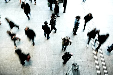 people walking on grey concrete floor during daytime photo
