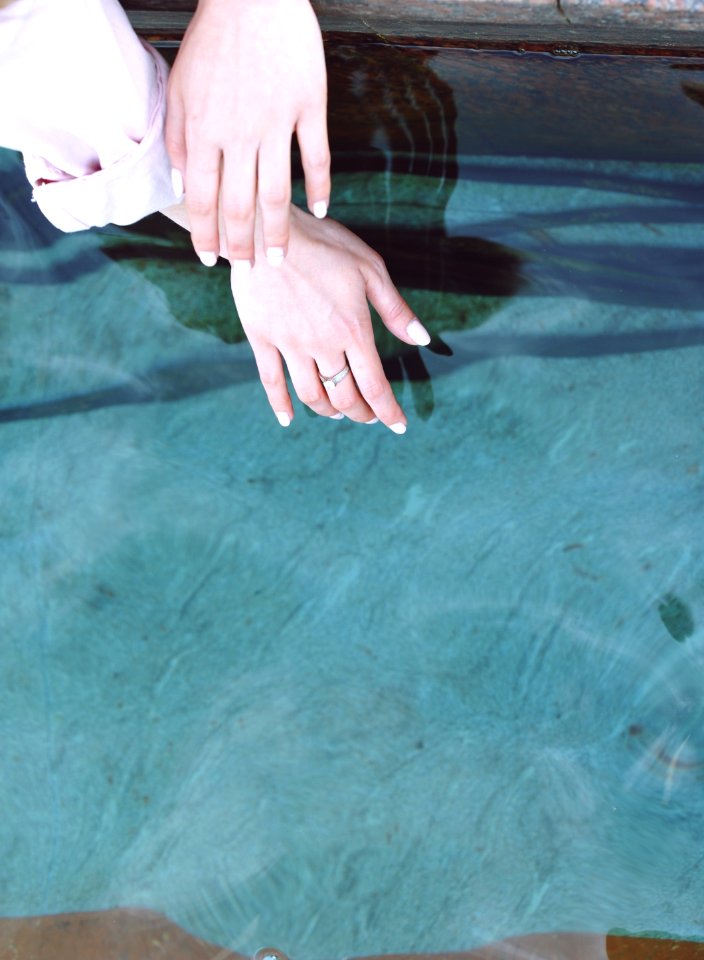 person wearing silver-colored ring